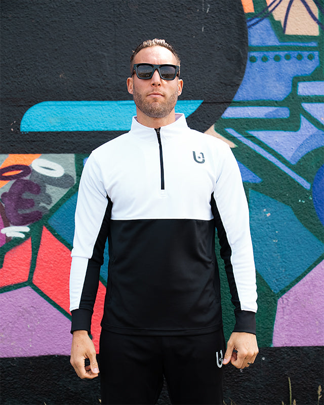 Front view of UNIFY white and black track top
