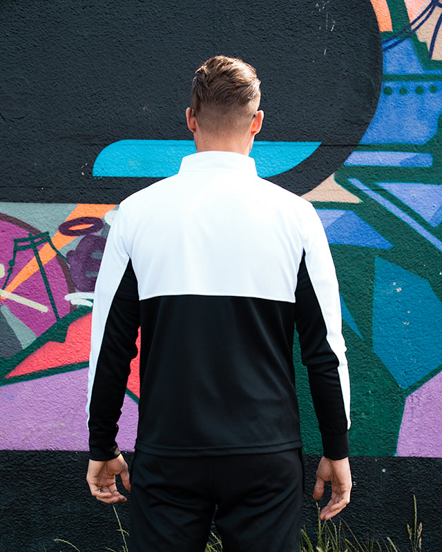 Model wearing UNIFY Motion Line white and black track top