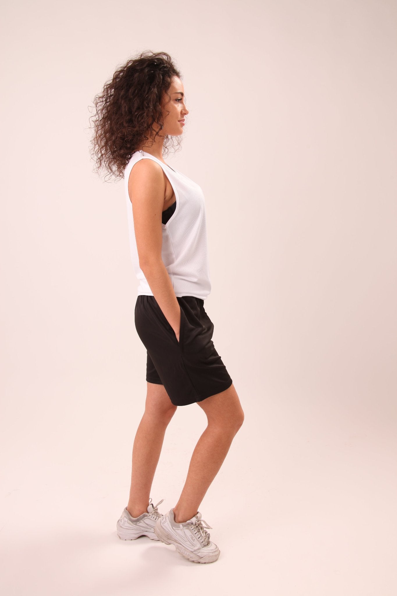 UNIFY women’s white ladies vest top, perfect for fitness enthusiasts, featuring a lightweight and soft polyester fabric.