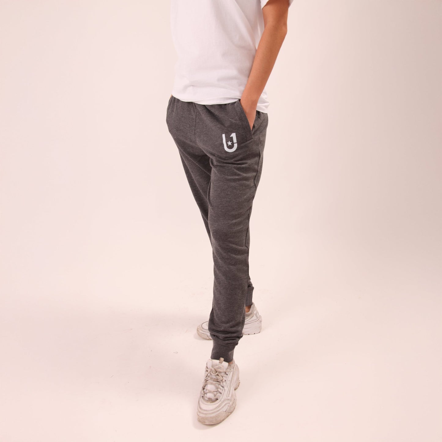 UNIFY women's grey joggers, perfect for a chic, comfortable look suitable for any activity.
