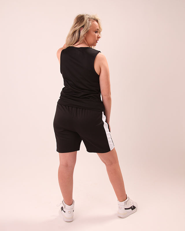 Close-up of waistband detail on women’s black and white UNIFY shorts