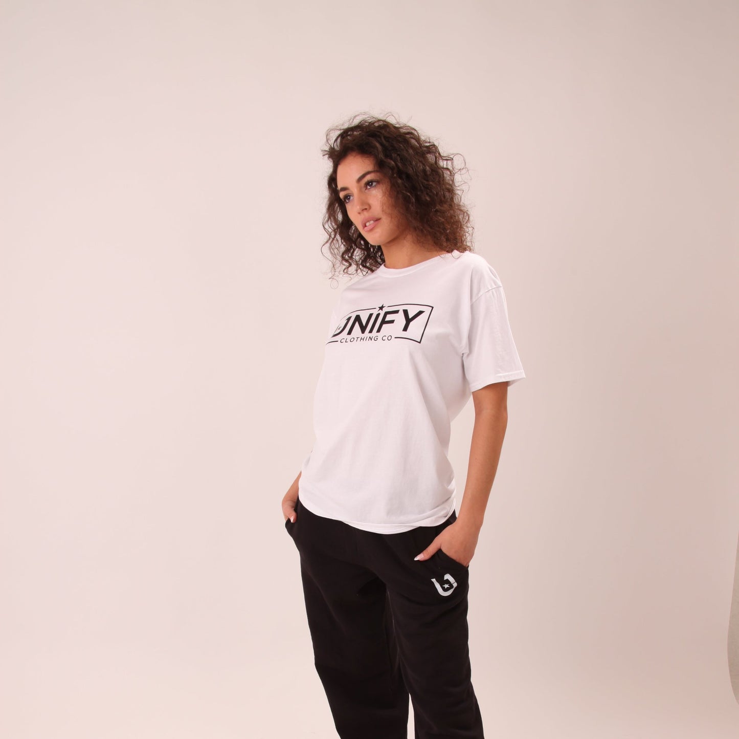 "Woman wearing a classic white tee, perfect for casual or dressy looks."
