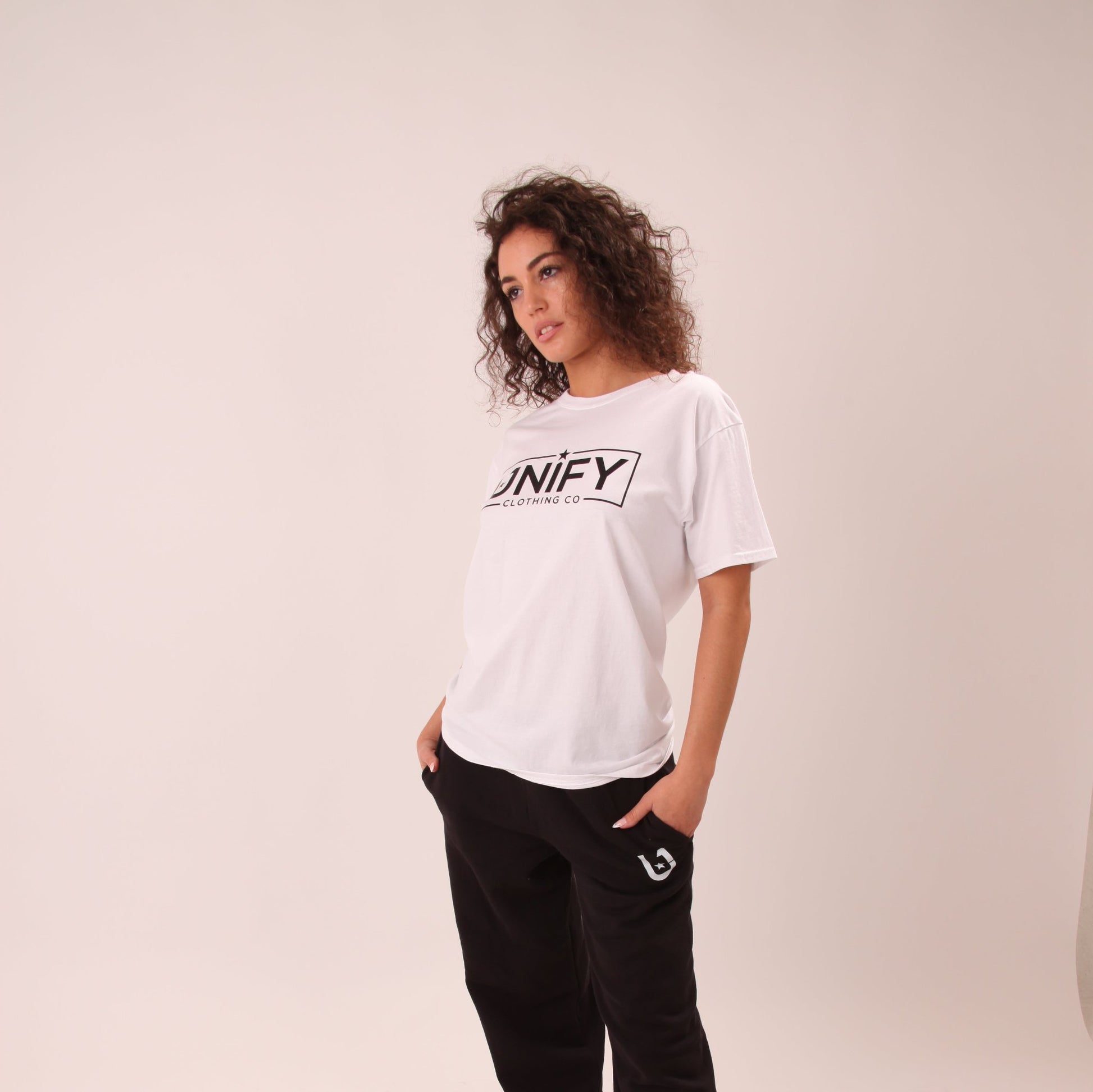"Woman wearing a classic white tee, perfect for casual or dressy looks."
