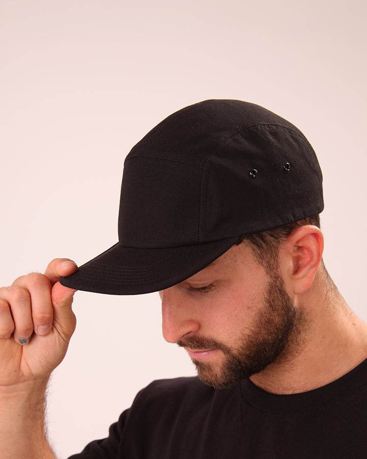 UNIFY's black streetwear cap displayed, featuring a minimalist design for maximum impact.