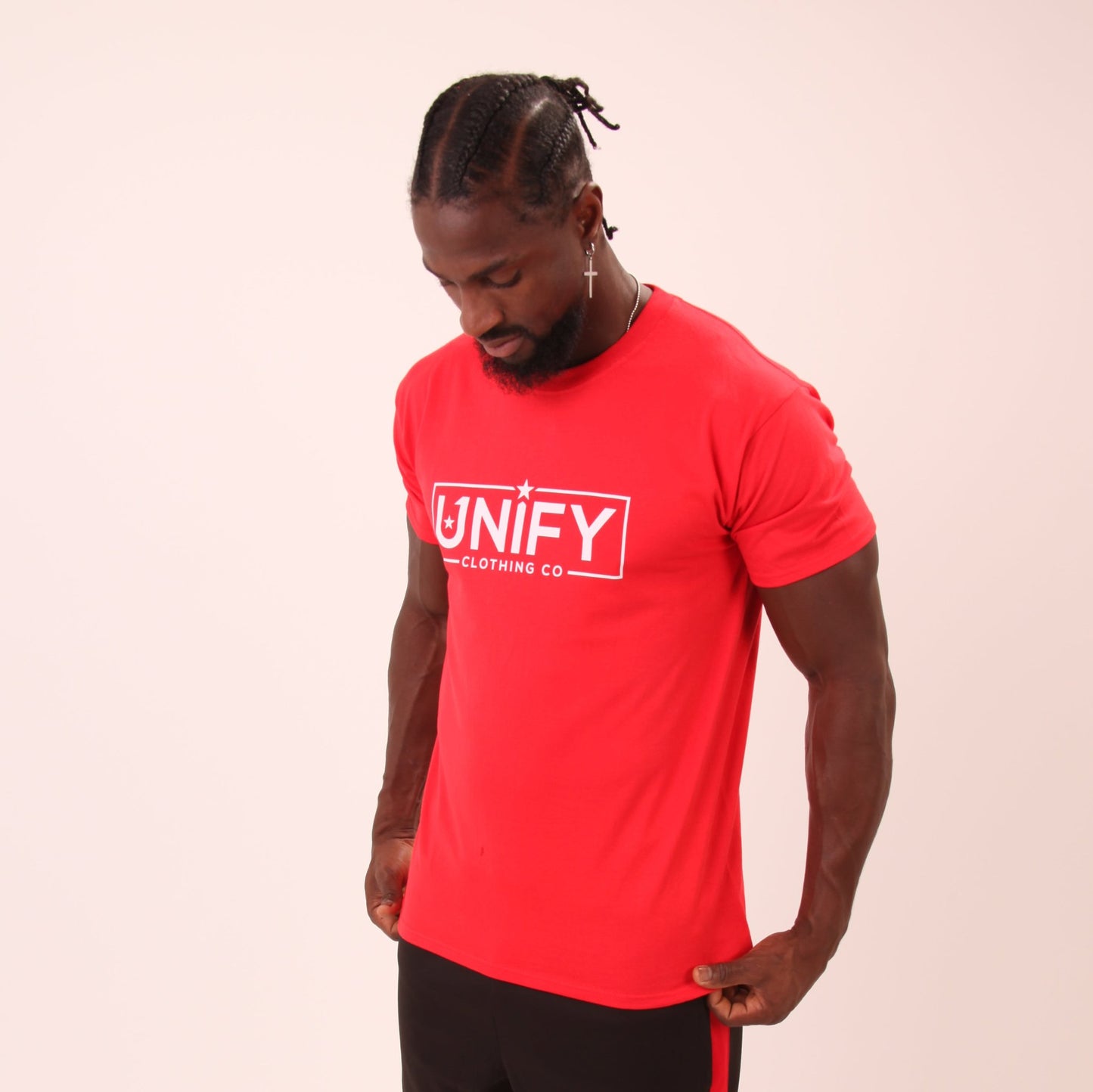 "UNIFY's signature red tee on a male model, showcasing its rich colour and comfortable fit."
