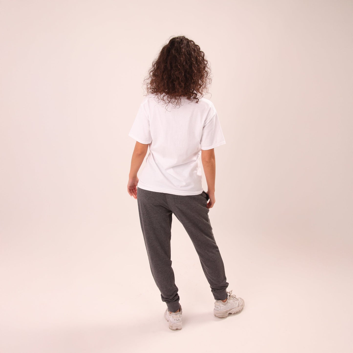 Fashion-forward UNIFY women's grey joggers styled for a casual outing, blending style and comfort.
