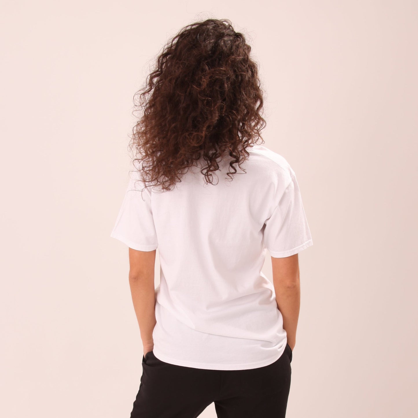 "Stylish woman in a heart-themed Pride tee by UNIFY, expressing love and support for the LGBTQ community."
