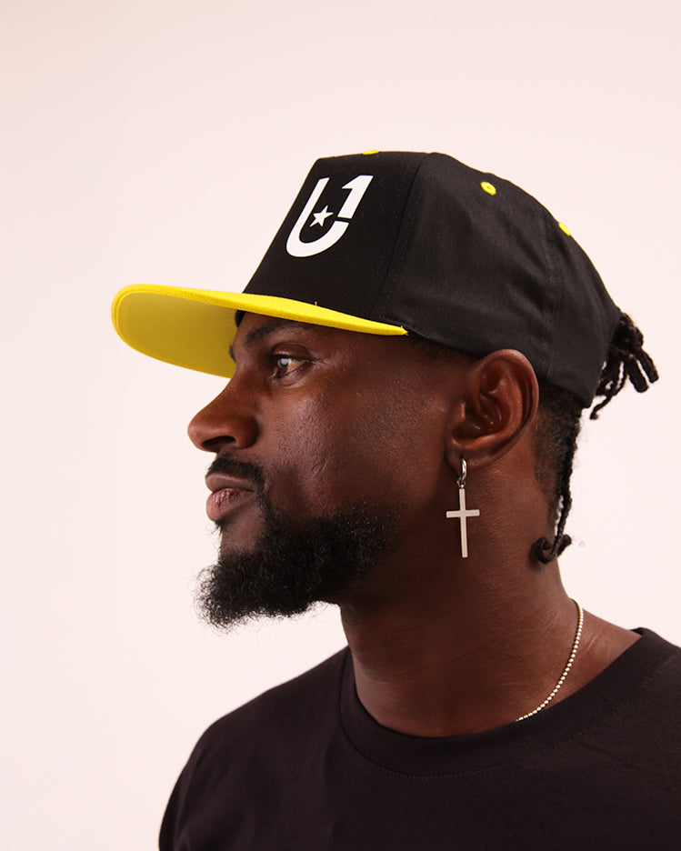 UNIFY high-performance yellow baseball hat on a beach setting, highlighting its cool features.